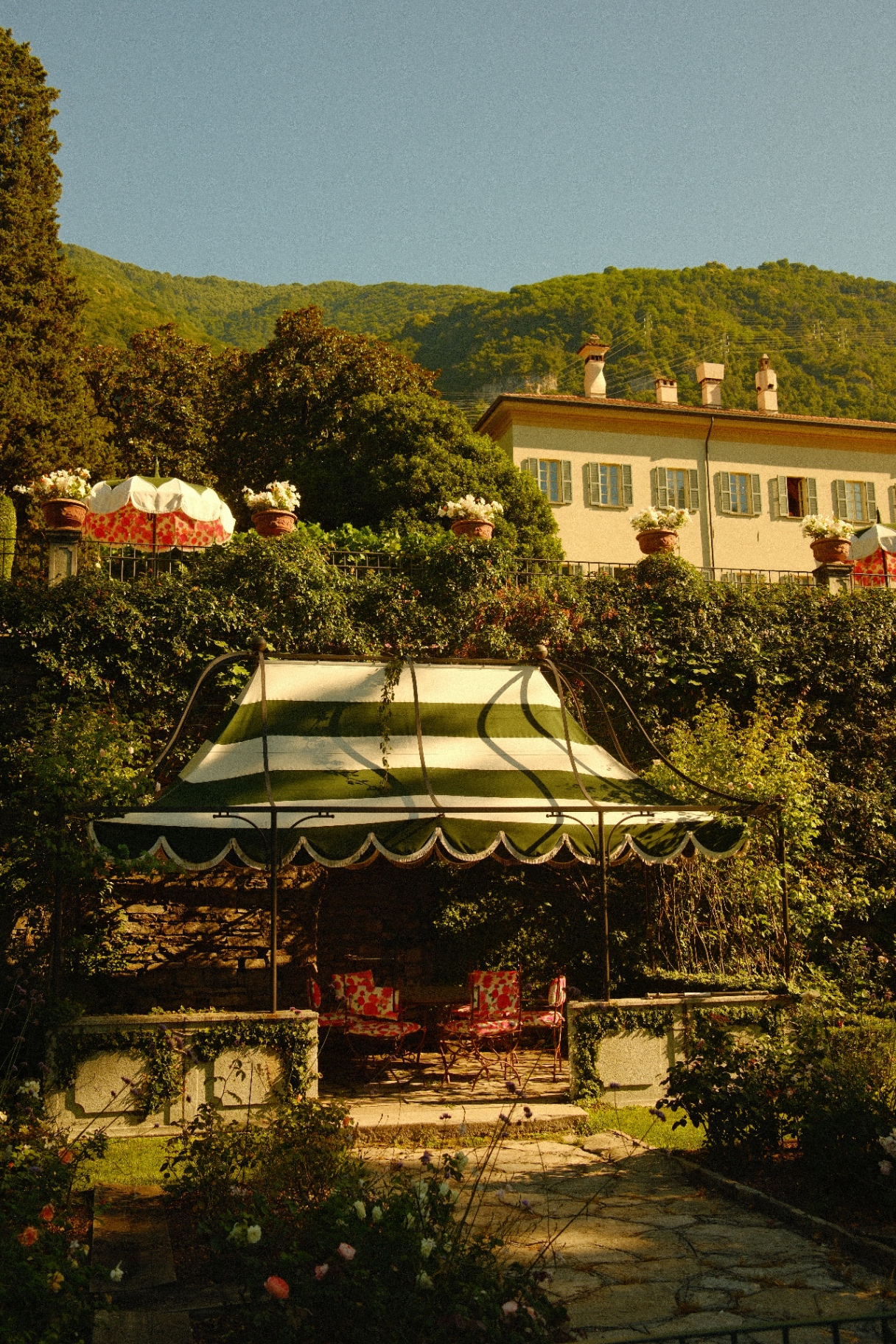 Classic villa and striped canopy above Lake Como