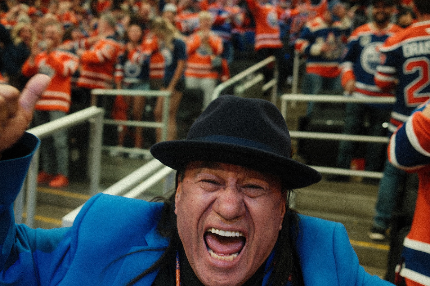 Portrait of a cheering fan in blue blazer and hat