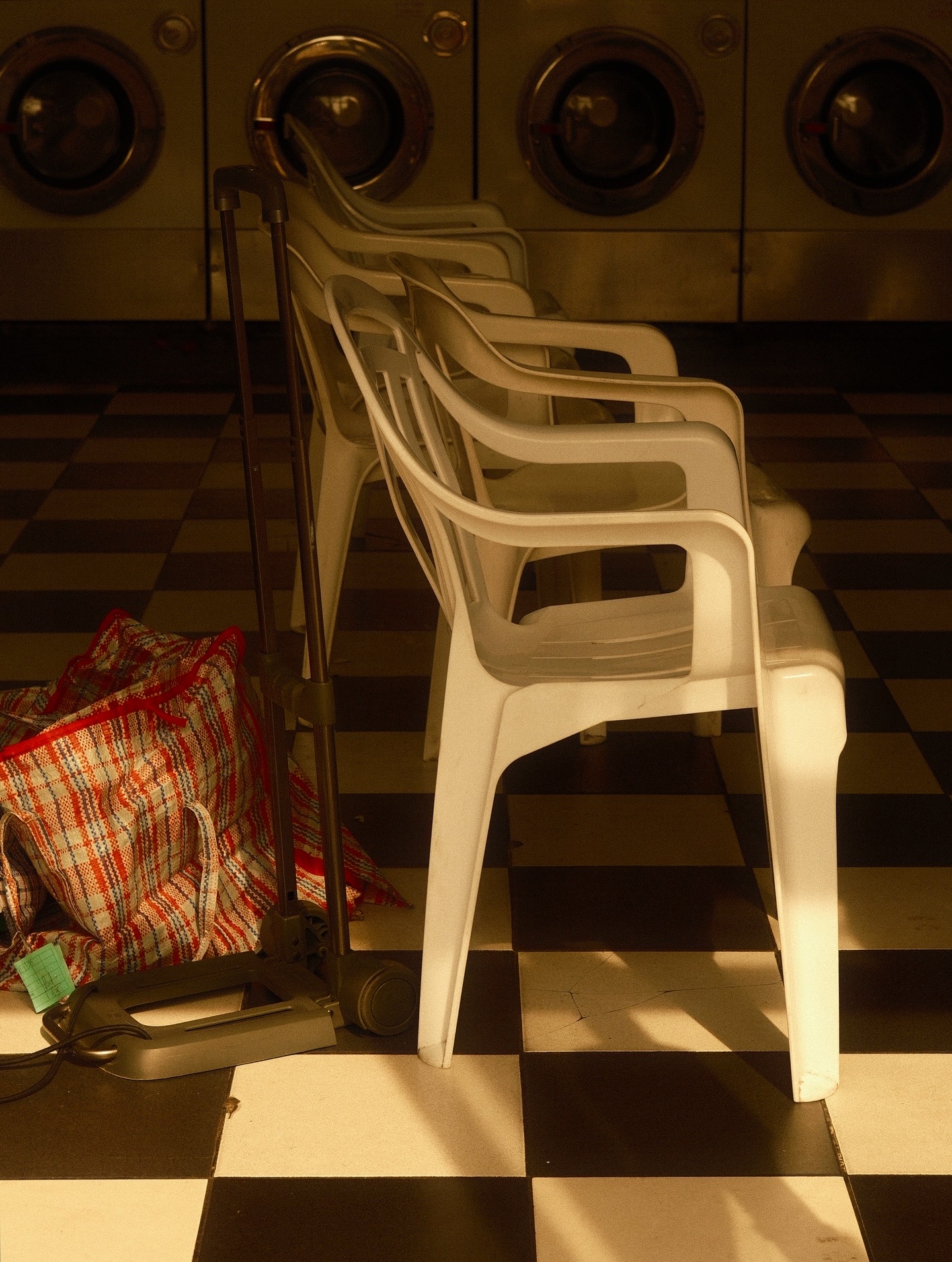 Stacked plastic chairs in a laundromat