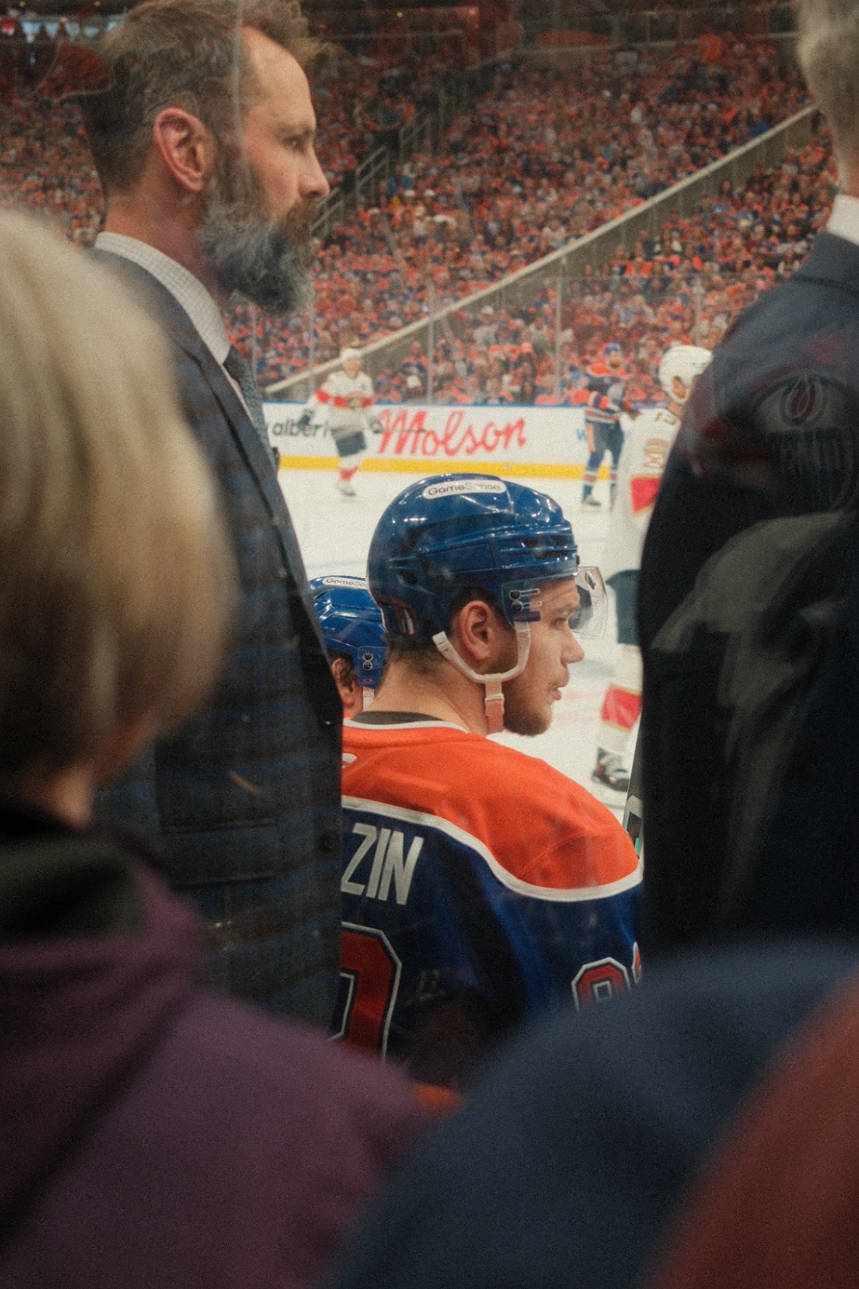 Coach and player profile through the rink glass