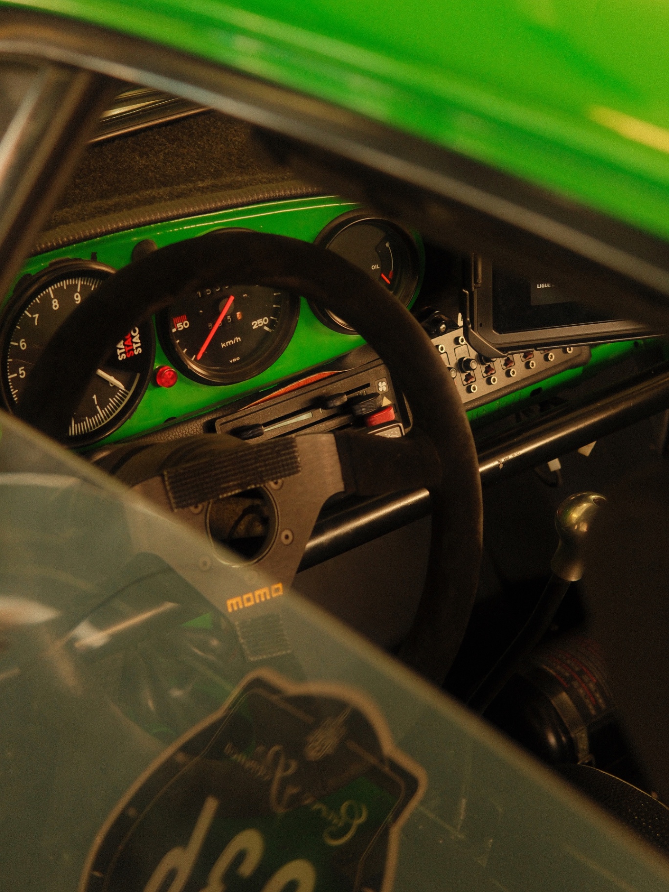 Through the side window of a green 911