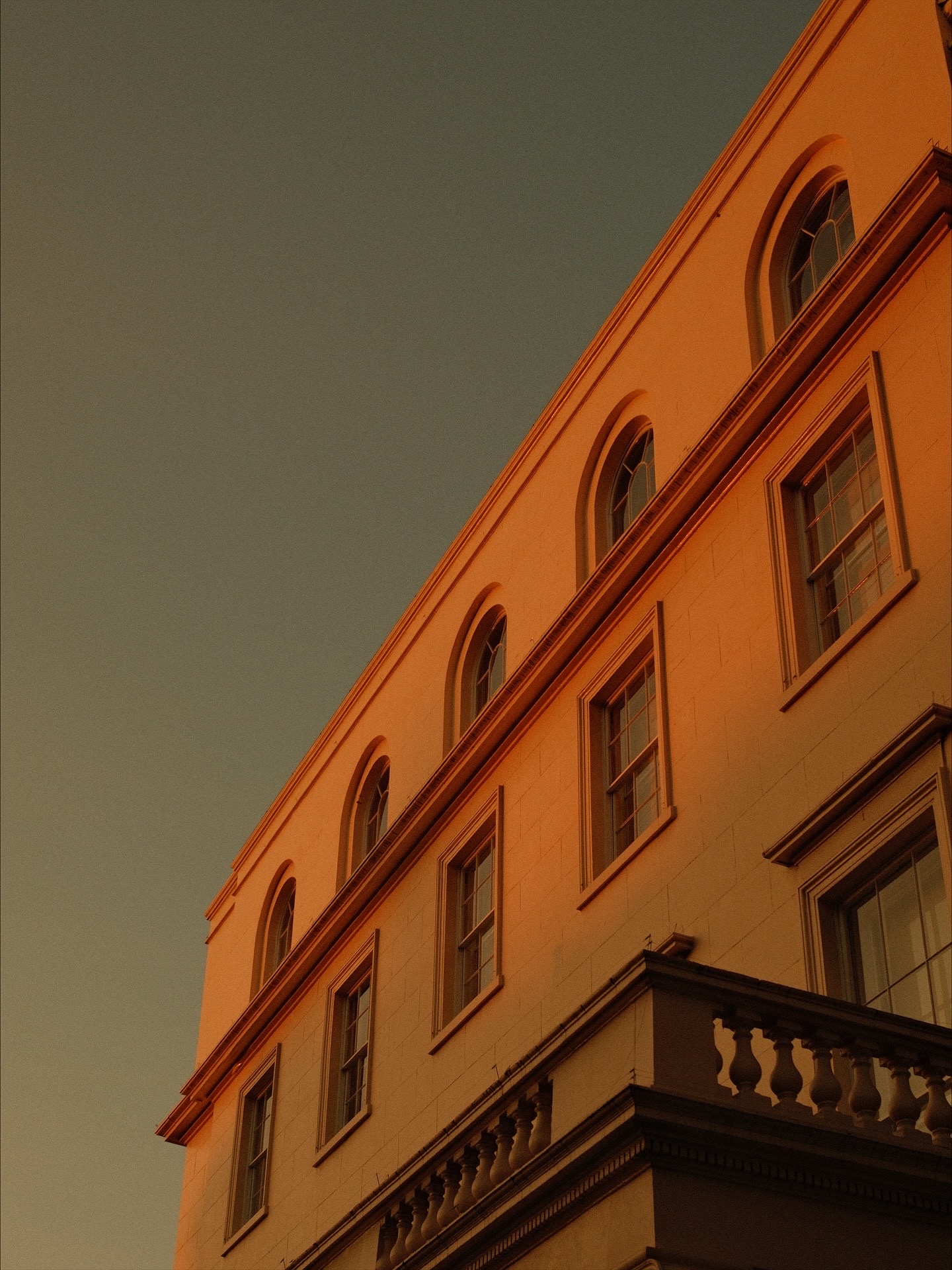 Warm ochre wall with arched windows