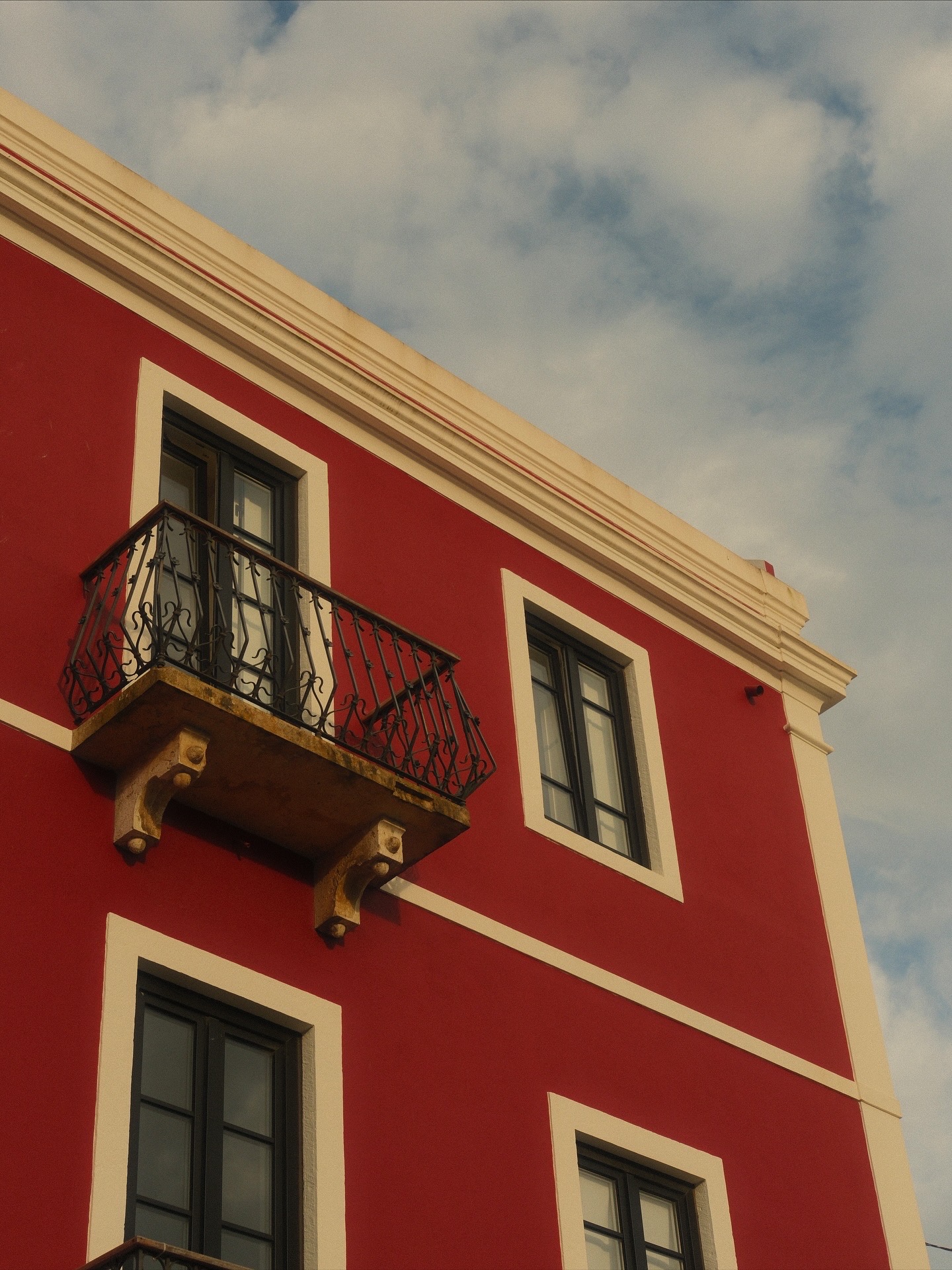 Red wall with iron balcony