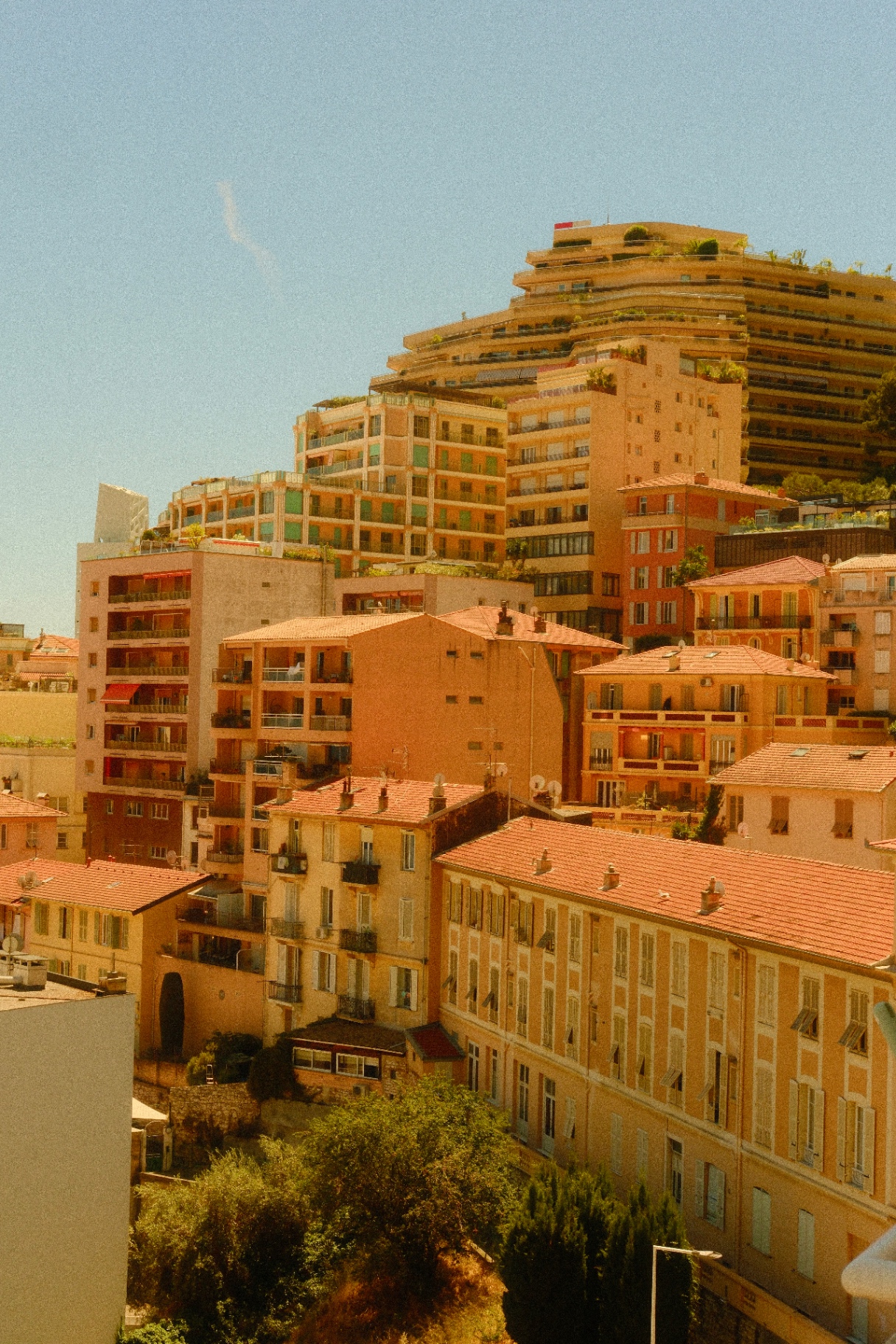 Monaco rooftops climbing the hillside in warm light