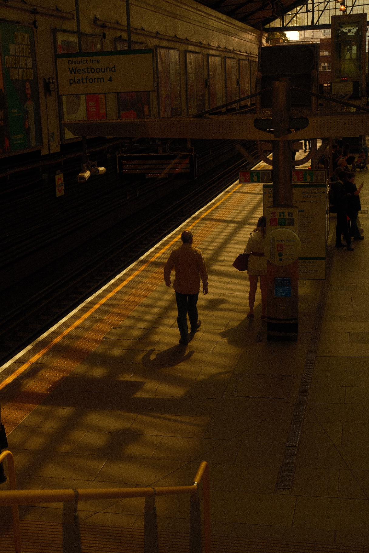 Westbound platform 4 at a London Underground station in low warm light
