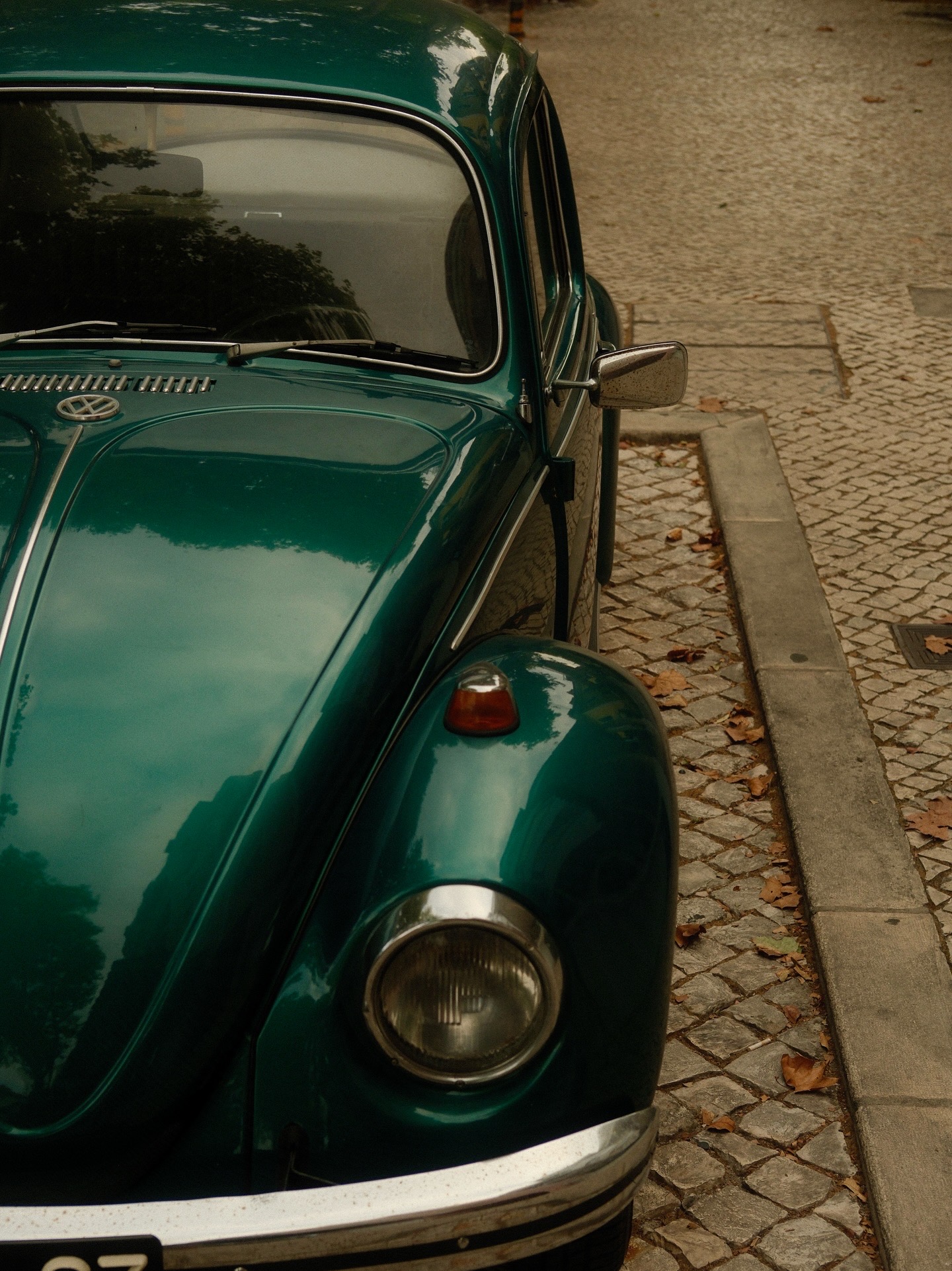 Teal vintage Beetle on cobbles