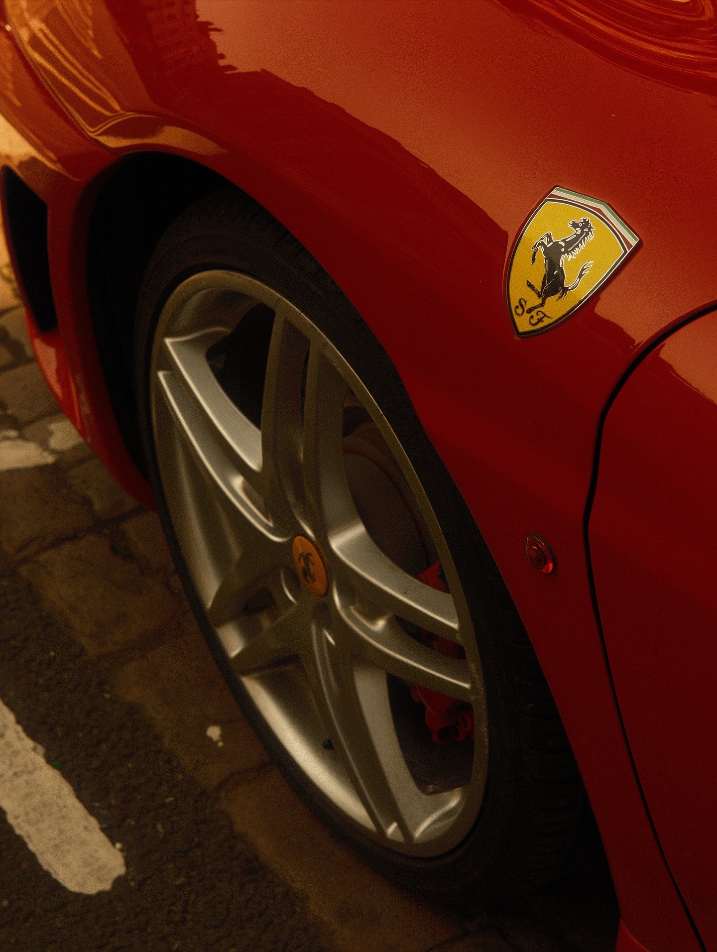 Ferrari front wheel under warm light