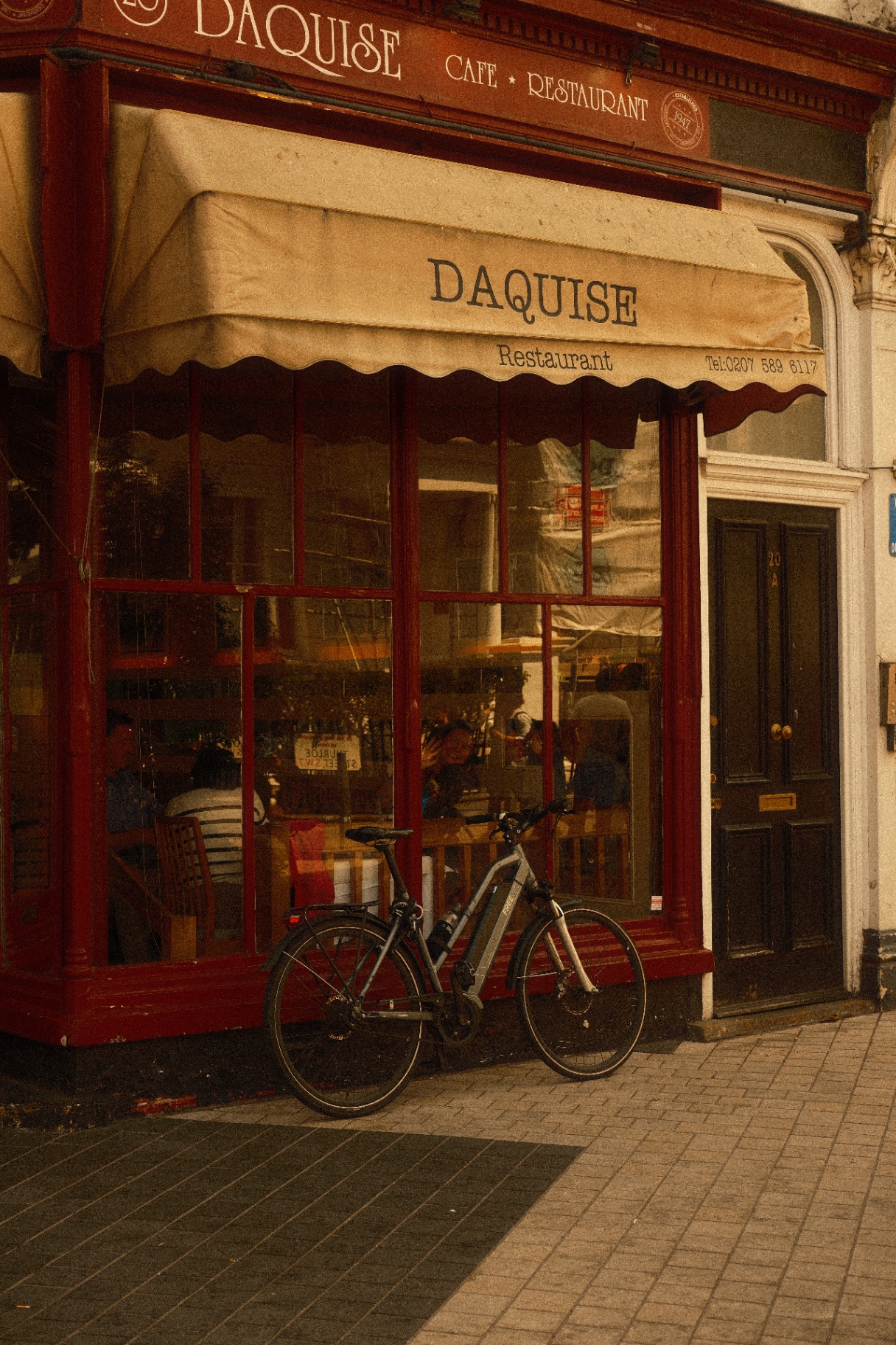 Daquise restaurant red shopfront in South Kensington with a bike out front