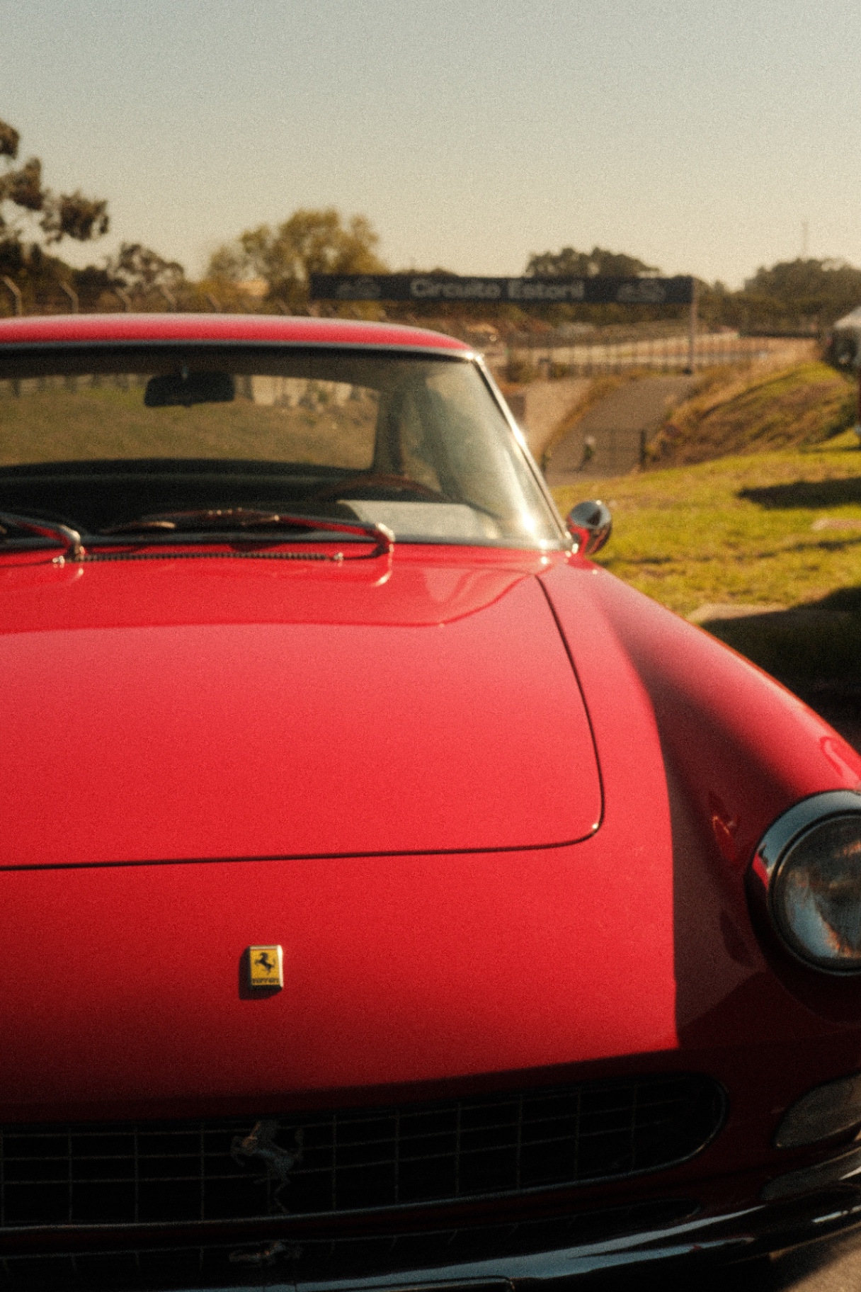 Red Ferrari front bonnet on the grass at Circuito Estoril